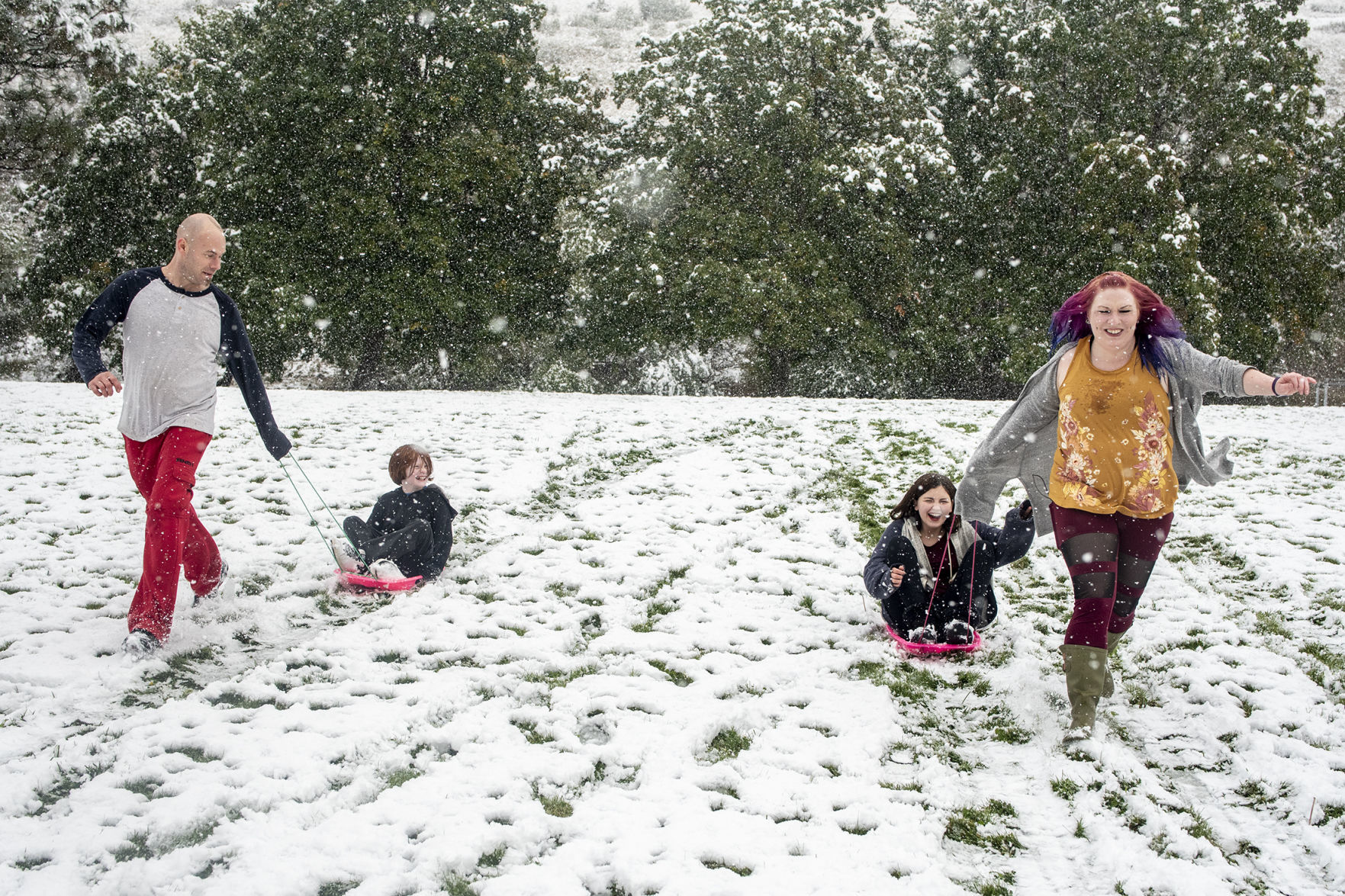 Little family sleds the hill